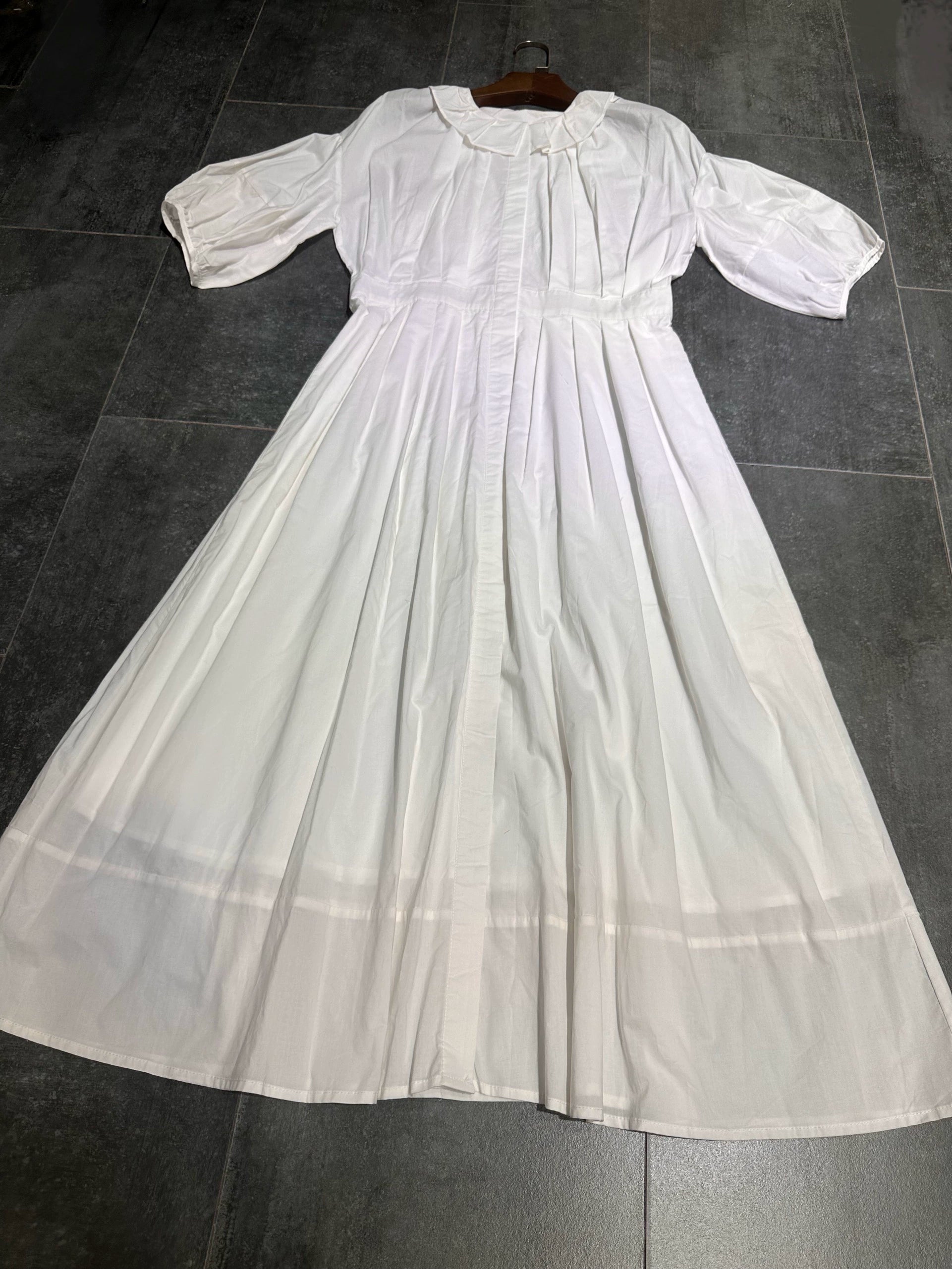 white midi dress with a crew neck and pleated lantern sleeves