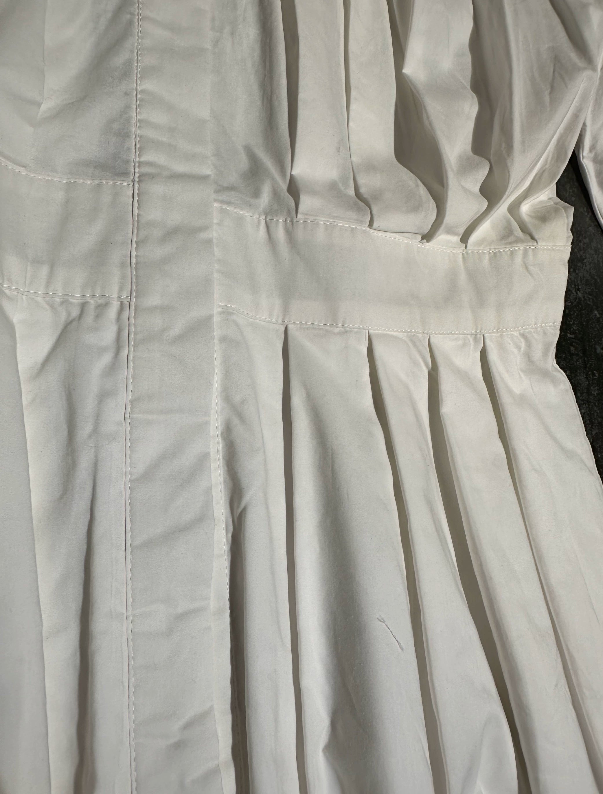 white midi dress with a crew neck and pleated lantern sleeves